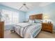 Bedroom features a large window with natural light, a wooden headboard and matching nightstands at 849 Wexford Blvd # 849, Venice, FL 34293