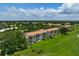Aerial view shows the exterior of the property and luscious grounds. This condo is ideally situated near green space at 849 Wexford Blvd # 849, Venice, FL 34293