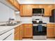 Well-maintained kitchen featuring stainless steel appliances and wooden cabinetry at 849 Wexford Blvd # 849, Venice, FL 34293
