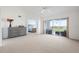Bright living room featuring a vaulted ceiling and sliding glass doors to a balcony at 849 Wexford Blvd # 849, Venice, FL 34293