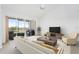 Bright living room featuring sliding glass doors to a balcony overlooking a golf course at 849 Wexford Blvd # 849, Venice, FL 34293