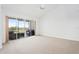 Bright living room featuring a vaulted ceiling and sliding glass doors to a balcony at 849 Wexford Blvd # 849, Venice, FL 34293