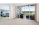 Bright living room featuring sliding glass doors to a balcony and carpet flooring at 849 Wexford Blvd # 849, Venice, FL 34293