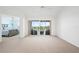 Bright living room with a sliding glass door to a balcony and carpet flooring at 849 Wexford Blvd # 849, Venice, FL 34293