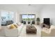 Bright living room featuring sliding glass doors to a balcony overlooking a golf course at 849 Wexford Blvd # 849, Venice, FL 34293