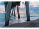 Tranquil beach scene with pier, calm waves, and a vibrant sunset, ideal for serene coastal living at 849 Wexford Blvd # 849, Venice, FL 34293