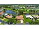 Aerial view of house featuring screened pool, landscaped yard, and golf course views at 925 S Doral Ln, Venice, FL 34293
