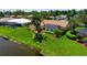 Serene aerial shot of home with a screened-in pool and a lush green lawn at 925 S Doral Ln, Venice, FL 34293