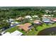 A cozy home showcases a screened-in pool and a well-maintained, lush green lawn at 925 S Doral Ln, Venice, FL 34293
