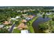 Beautiful aerial view of home with a screened-in pool, verdant lawn, and mature landscaping at 925 S Doral Ln, Venice, FL 34293