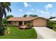Well-maintained single-story home with lush landscaping and a long driveway at 925 S Doral Ln, Venice, FL 34293