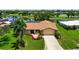 Charming single-story home with well-manicured lawn, landscaping, and water views at 925 S Doral Ln, Venice, FL 34293