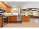 Open kitchen featuring stainless steel appliances, granite countertops and beautiful wood cabinets overlooking the living area at 925 S Doral Ln, Venice, FL 34293