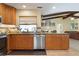 Open kitchen featuring stainless steel appliances, granite countertops and beautiful wood cabinets overlooking the living area at 925 S Doral Ln, Venice, FL 34293