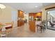 Open kitchen featuring stainless steel appliances, granite countertops and beautiful wood cabinets with a breakfast bar at 925 S Doral Ln, Venice, FL 34293
