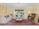 Living room with neutral walls, comfortable seating, and view to the lanai at 925 S Doral Ln, Venice, FL 34293