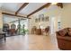 Open living room featuring vaulted ceilings with wood beams, tile floors and access to the outdoor living area at 925 S Doral Ln, Venice, FL 34293