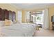 Comfortable main bedroom with access to the lanai and views of the pool area at 925 S Doral Ln, Venice, FL 34293