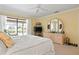 Bright main bedroom features lanai access, dresser, and a large circular mirror at 925 S Doral Ln, Venice, FL 34293