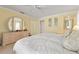 Well-lit main bedroom features a dresser, closet access, and ensuite bathroom at 925 S Doral Ln, Venice, FL 34293
