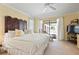 Spacious main bedroom featuring lanai access, a king bed, and neutral decor at 925 S Doral Ln, Venice, FL 34293