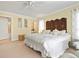 Inviting main bedroom with a king bed, neutral tones, and access to ensuite bathroom at 925 S Doral Ln, Venice, FL 34293