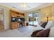 Home office with built-in desk and pool view through sliding glass door at 925 S Doral Ln, Venice, FL 34293