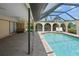 Inviting pool within a screened enclosure and covered lanai with ceiling fan at 925 S Doral Ln, Venice, FL 34293