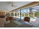 Covered outdoor dining area with ceiling fans overlooking the pool at 925 S Doral Ln, Venice, FL 34293