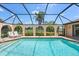 Inviting pool featuring screened enclosure and lush greenery at 925 S Doral Ln, Venice, FL 34293