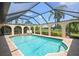 Sparkling pool with a screened enclosure offers serene views and ample sunlight at 925 S Doral Ln, Venice, FL 34293