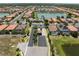 A picturesque aerial shot shows a community with terracotta roofs, lush landscaping, and tranquil lakes at 9917 Haze Dr, Venice, FL 34292