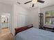 Bedroom featuring a spacious closet, ceiling fan, and computer desk, creating a relaxing and organized space at 9917 Haze Dr, Venice, FL 34292