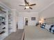 Bedroom showcasing the bookcase, ceiling fan, and closet space, creating an organized and stylish space at 9917 Haze Dr, Venice, FL 34292