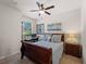 Comfortable bedroom showcasing a work desk, a bright window and a ceiling fan at 9917 Haze Dr, Venice, FL 34292