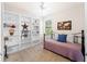Bedroom showcasing built-in shelving, a ceiling fan, and plenty of natural light at 9917 Haze Dr, Venice, FL 34292