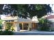 Inviting building entrance with manicured landscaping, decorative planters and covered walkway at 9917 Haze Dr, Venice, FL 34292