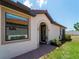 Charming home exterior featuring a red tile roof, arched entrance, and well-maintained landscaping at 9917 Haze Dr, Venice, FL 34292