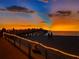 Scenic view of the fishing pier at sunset with families enjoying an evening stroll at 9917 Haze Dr, Venice, FL 34292