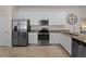 Modern kitchen with stainless steel appliances, granite countertops, and white cabinetry at 9917 Haze Dr, Venice, FL 34292