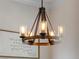 Close up of a decorative hanging light fixture above a dining table in a dining room at 9917 Haze Dr, Venice, FL 34292