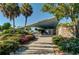 Exterior view of a beach pavilion, showcasing its mid-century design and surrounding lush greenery at 9917 Haze Dr, Venice, FL 34292