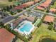 Aerial shot of clubhouse and pool area, with palm trees and lush landscaping, surrounded by residences at 9917 Haze Dr, Venice, FL 34292