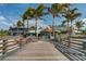 An entryway with palm trees leads to beachside dining at Sharky's on the Pier at 9917 Haze Dr, Venice, FL 34292