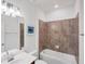 Bright bathroom with tiled shower/bathtub, decorative artwork, and a sleek vanity at 10061 Cozy Grove Dr, Venice, FL 34293