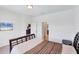 Bedroom with a bed, neutral decor, and an open doorway leading to another living area at 10061 Cozy Grove Dr, Venice, FL 34293