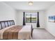 Bedroom with a plush bed, window with outdoor views and a wall-mounted television screen at 10061 Cozy Grove Dr, Venice, FL 34293