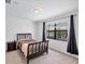 Bedroom featuring a dark wood bed frame, side table, and window with tranquil water views at 10061 Cozy Grove Dr, Venice, FL 34293
