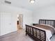 Bedroom showcasing a bed, neutral decor, and open doorway leading to the bathroom at 10061 Cozy Grove Dr, Venice, FL 34293