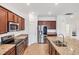 Spacious kitchen features stainless steel appliances, granite countertops, and ample cabinet space at 10061 Cozy Grove Dr, Venice, FL 34293